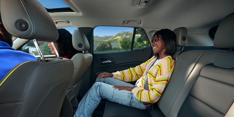woman seating in back seat of Chevy Trax